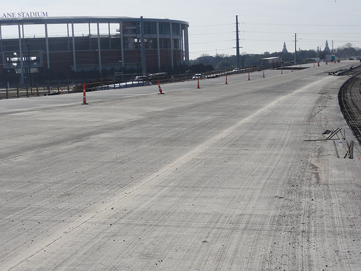 New pavement on I-35 with Baylor University’s McLane Stadium in the background
